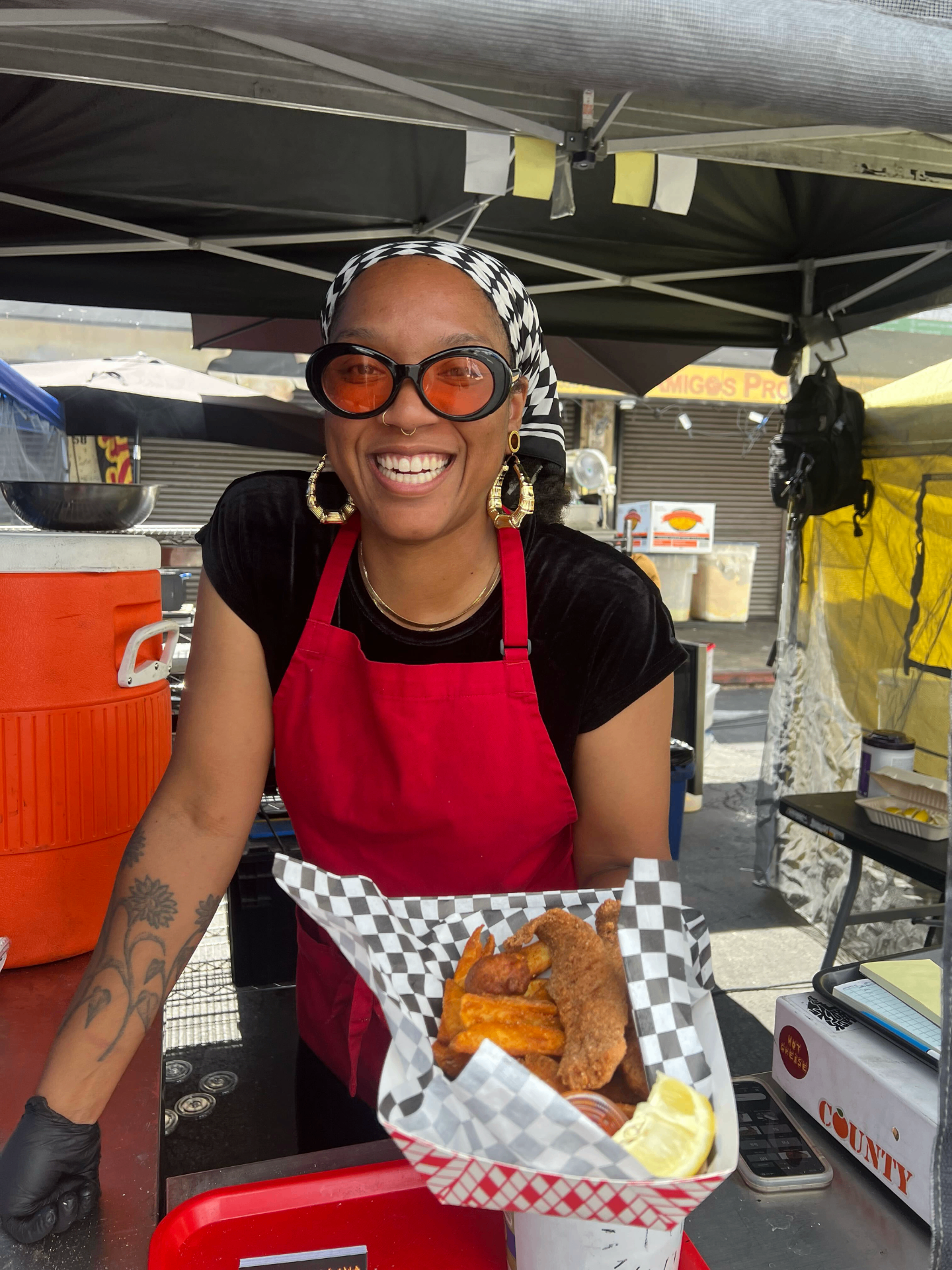 Asha Starks, founder of Hot Grease, smiling at the fish fry stand